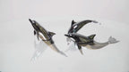 Harmony Dolphin Set by Waterines — 3D sculpted magnetic resin dolphin sculptures swim across a glass coffee table.