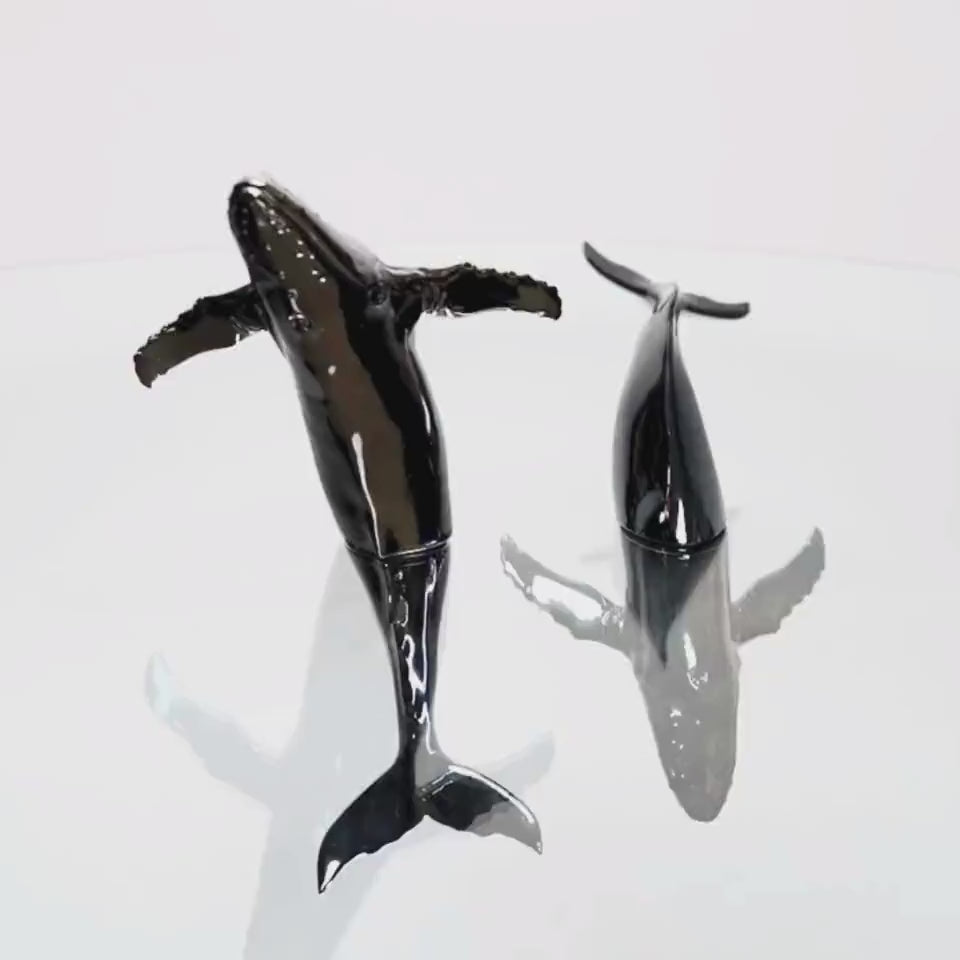 Euphoria Whale Set by Waterines — 3D sculpted magnetic resin whale sculptures breach through a glass coffee table.