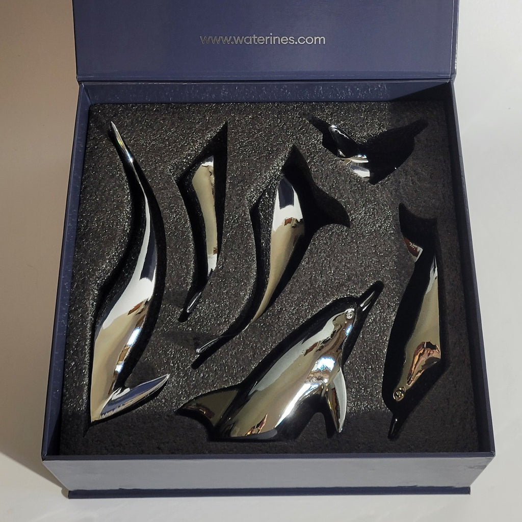 Harmony Dolphin Set by Waterines — 3D sculpted magnetic resin dolphin sculptures swim across a glass coffee table.