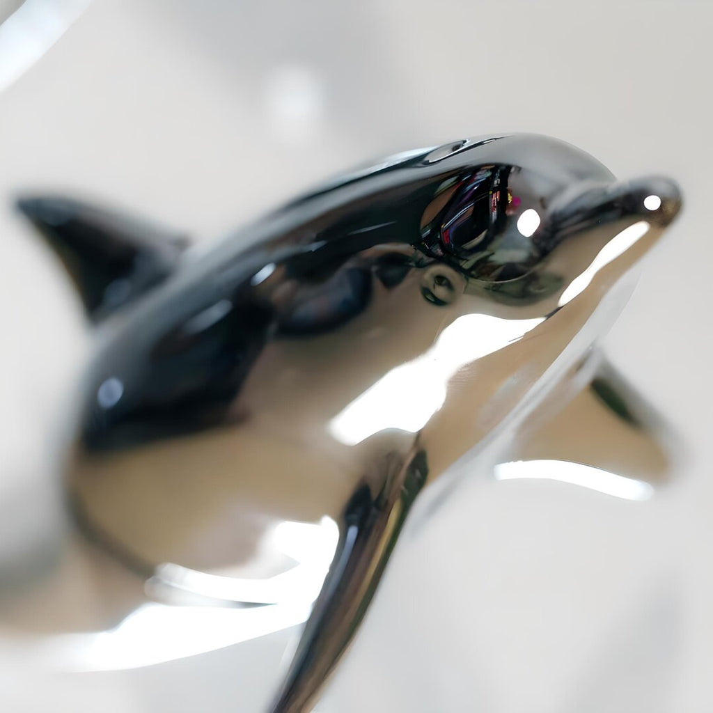 Harmony Dolphin Set by Waterines — 3D sculpted magnetic resin dolphin sculptures swim across a glass coffee table.