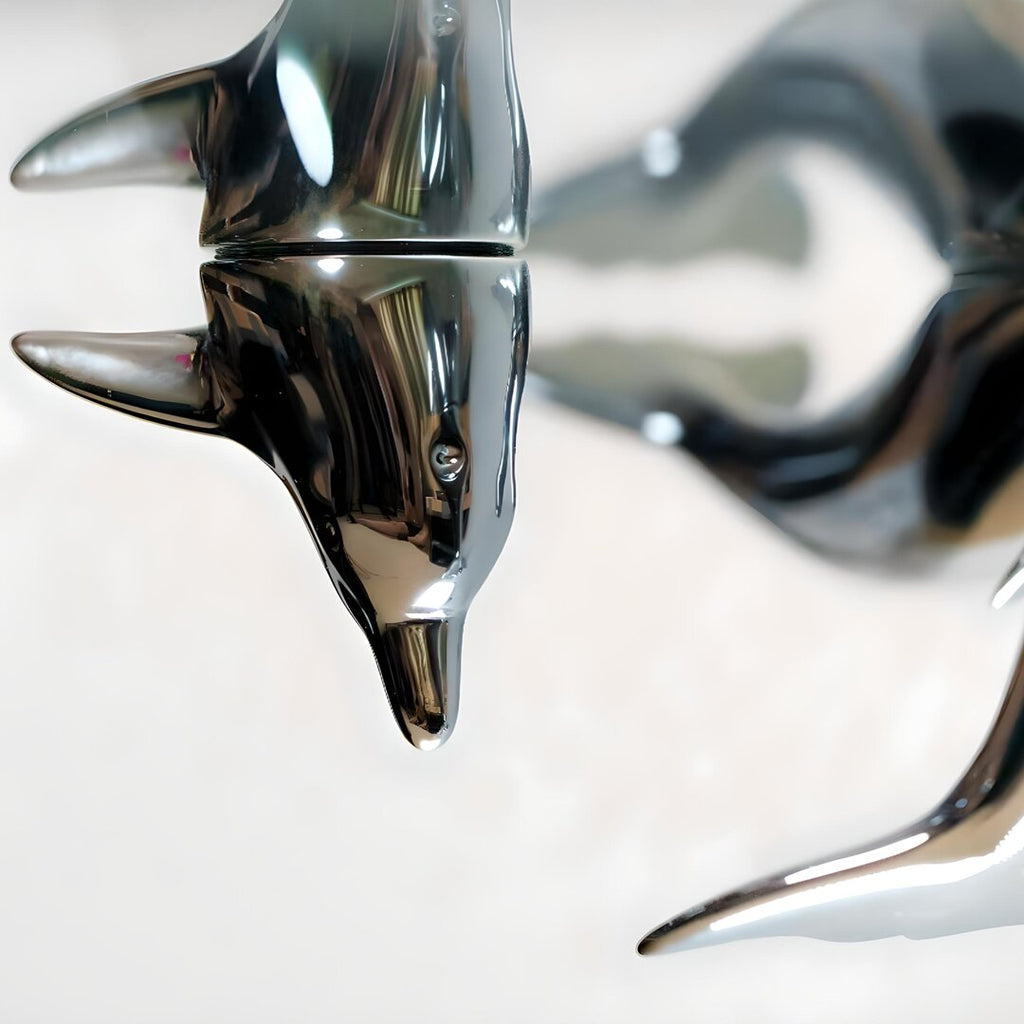 Harmony Dolphin Set by Waterines — 3D sculpted magnetic resin dolphin sculptures swim across a glass coffee table.