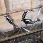 Harmony Dolphin Set by Waterines — 3D sculpted magnetic resin dolphin sculptures swim across a glass coffee table.