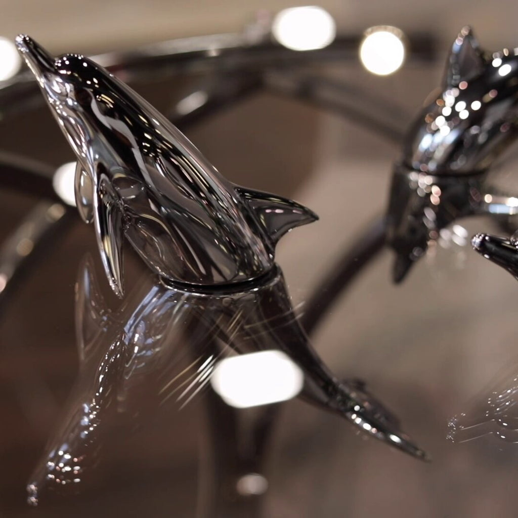 Harmony Dolphin Set by Waterines — 3D sculpted magnetic resin dolphin sculptures swim across a glass coffee table.
