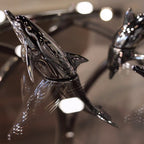 Harmony Dolphin Set by Waterines — 3D sculpted magnetic resin dolphin sculptures swim across a glass coffee table.