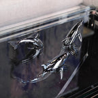 Harmony Dolphin Set by Waterines — 3D sculpted magnetic resin dolphin sculptures swim across a glass coffee table.