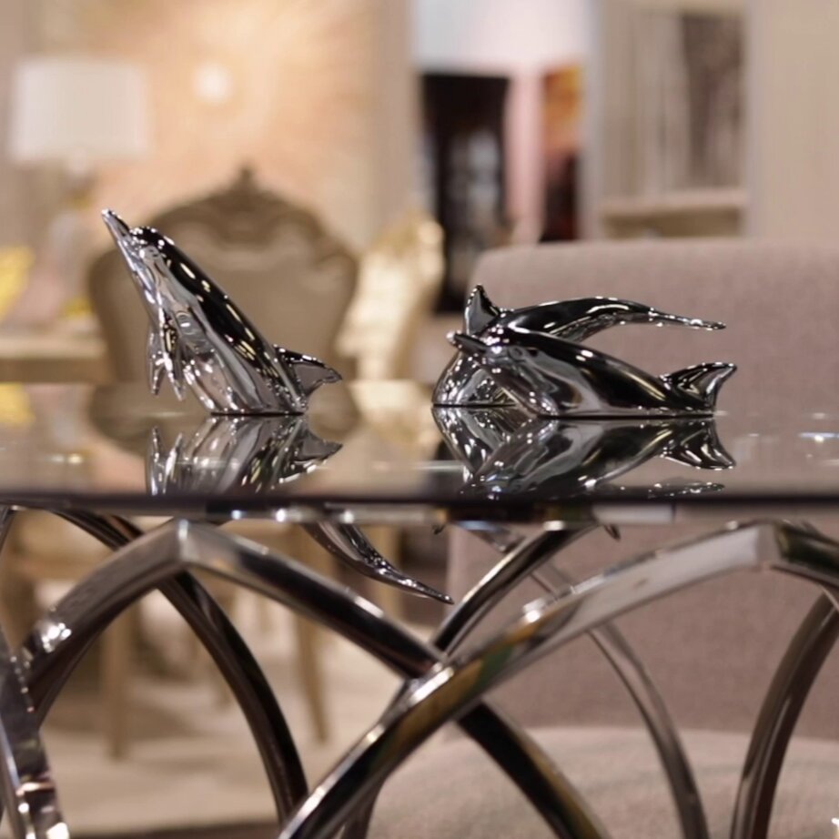 Harmony Dolphin Set by Waterines — 3D sculpted magnetic resin dolphin sculptures swim across a glass coffee table.