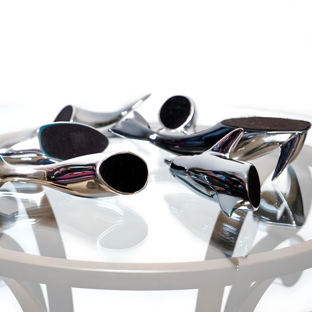 Harmony Dolphin Set by Waterines — 3D sculpted magnetic resin dolphin sculptures swim across a glass coffee table.