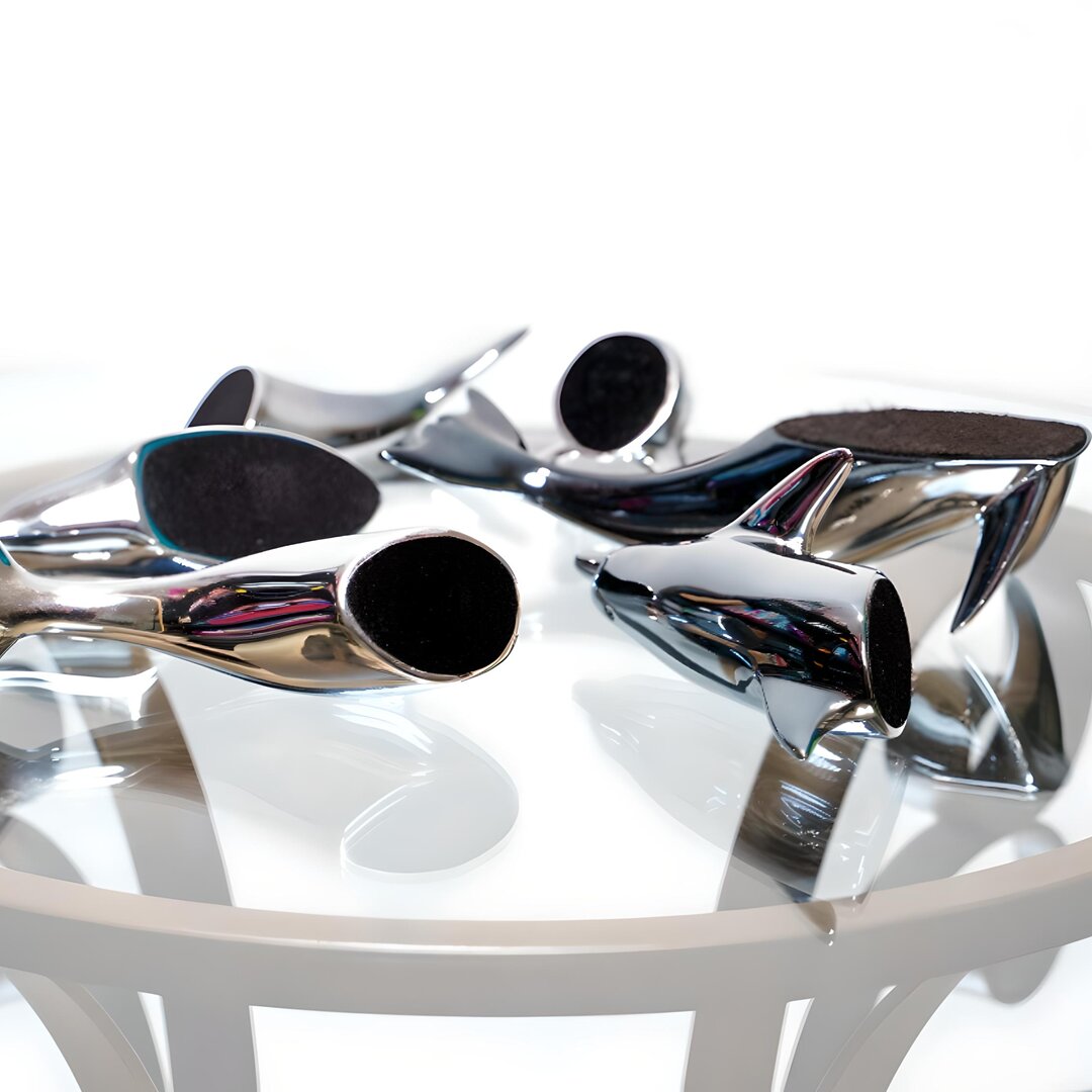 Harmony Dolphin Set by Waterines — 3D sculpted magnetic resin dolphin sculptures swim across a glass coffee table.