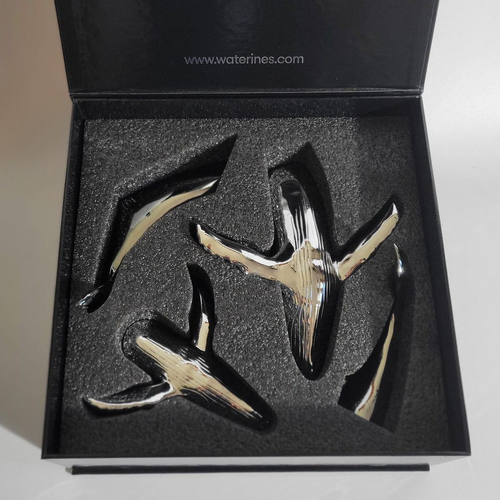 Euphoria Whale Set by Waterines — 3D sculpted magnetic resin whale sculptures breach through a glass coffee table.