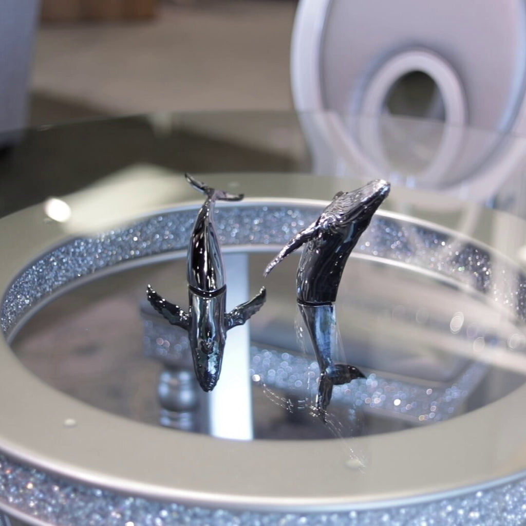 Euphoria Whale Set by Waterines — 3D sculpted magnetic resin whale sculptures breach through a glass coffee table.