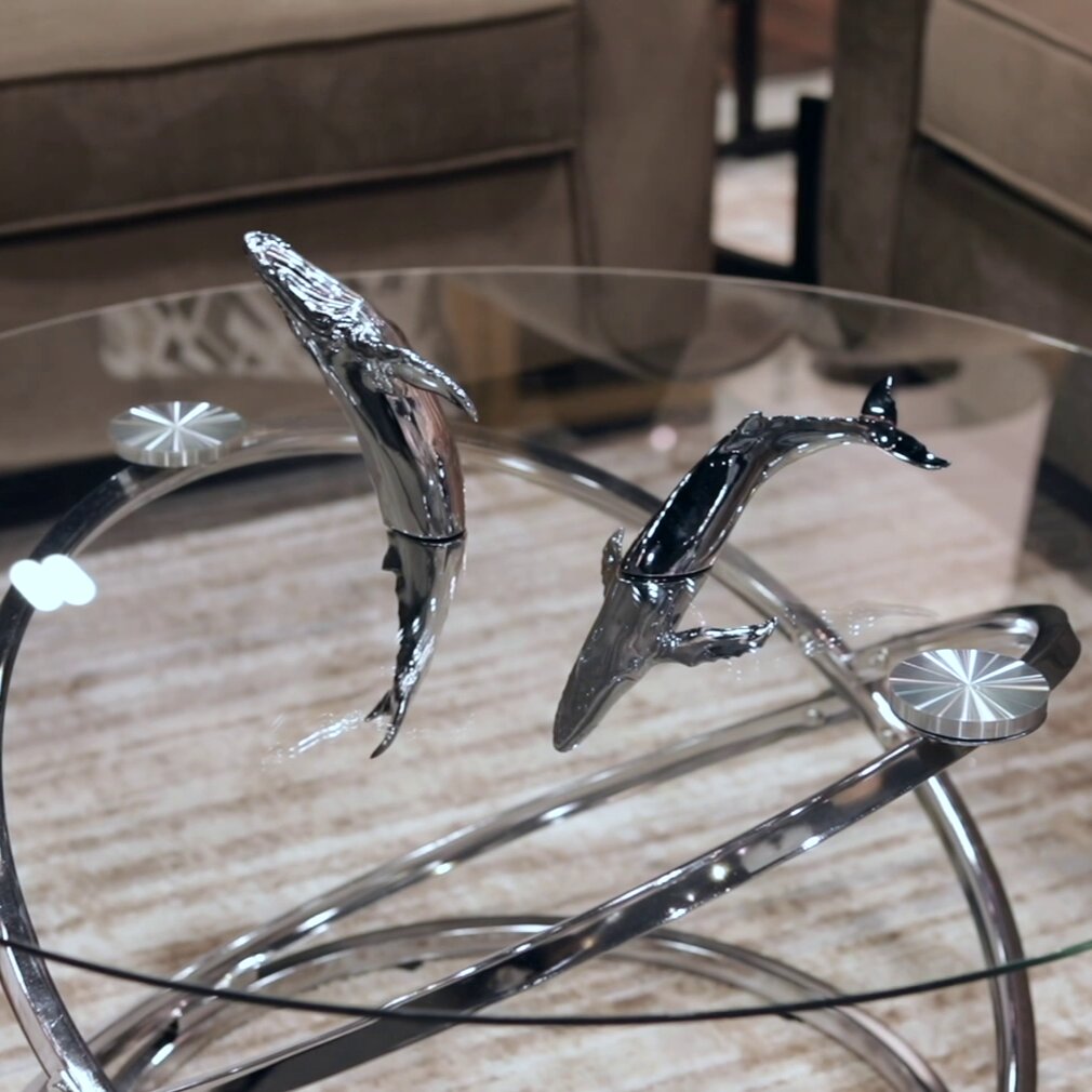 Euphoria Whale Set by Waterines — 3D sculpted magnetic resin whale sculptures breach through a glass coffee table.
