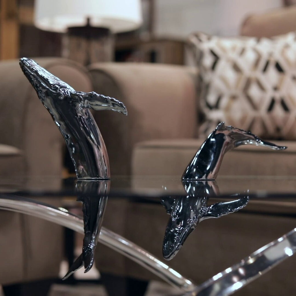 Euphoria Whale Set by Waterines — 3D sculpted magnetic resin whale sculptures breach through a glass coffee table.