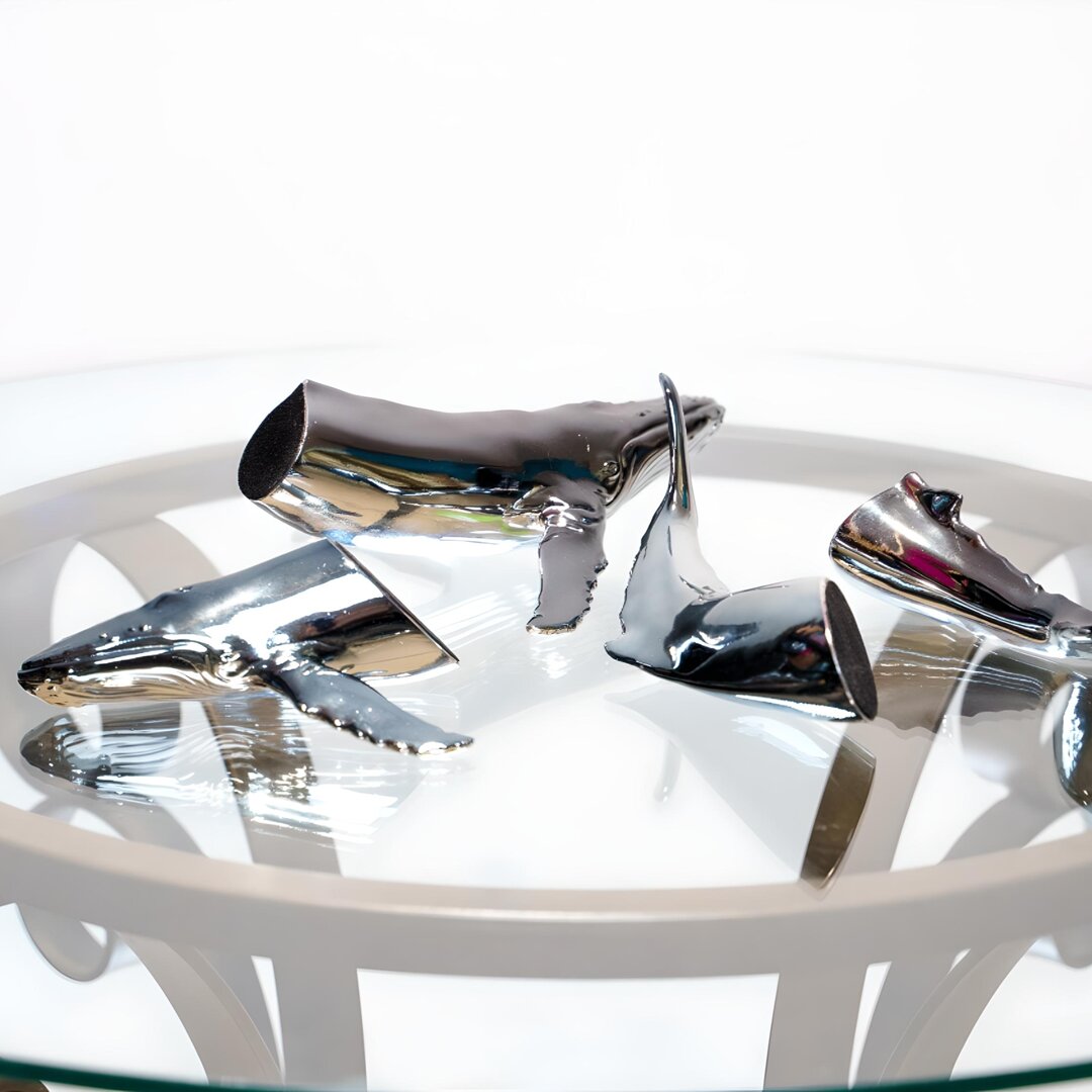 Euphoria Whale Set by Waterines — 3D sculpted magnetic resin whale sculptures breach through a glass coffee table.